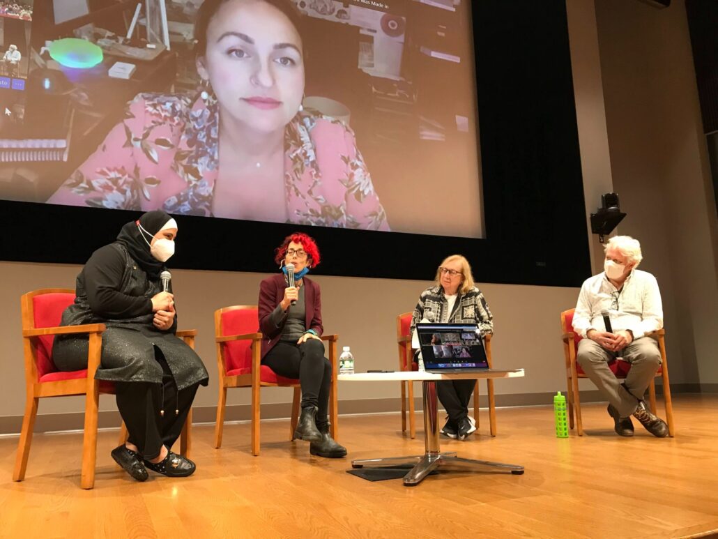 panelists in a presentation room having a discussion