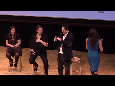 Four panelists, a man and three women, take the stage, sitting on wooden stools.