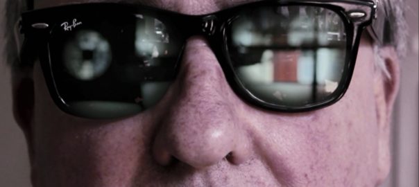 A man's face with glasses on
