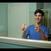 A man looks at himself in the mirror