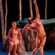 Two people perform on a stage