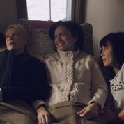 a group of people lean back on a couch together