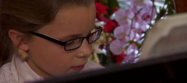 A girl plays the piano