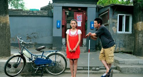 A man talks to a woman on the street