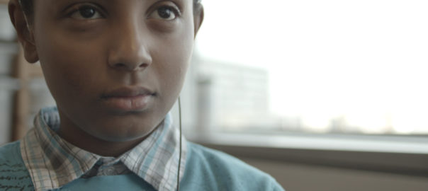 A boy with headphones in