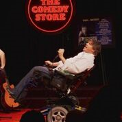 A man in a wheelchair on a performing stage