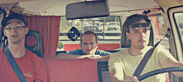Three people drive in a car