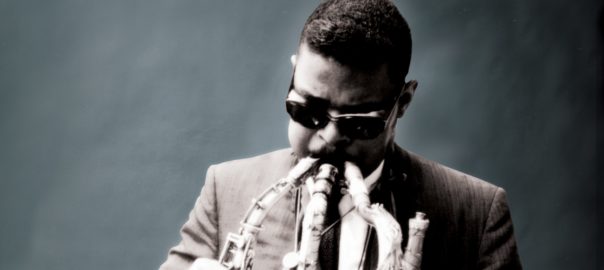 A man plays multiple brass instruments