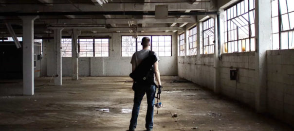 A person stands in a completley empty warehouse space