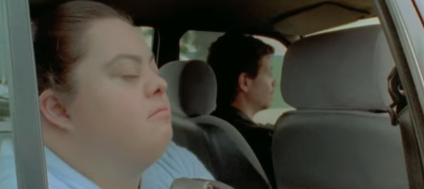 A woman looks out of a window while another woman drives