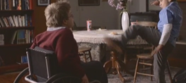 A child raises his leg in a karate kick motion towards another child in a wheelchair