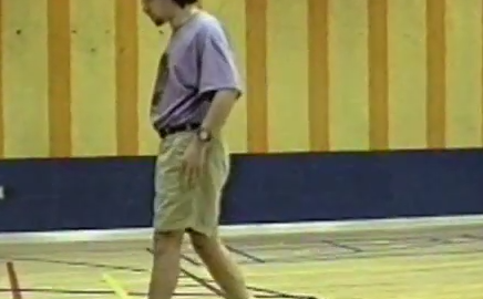 A man walks across a gym floor