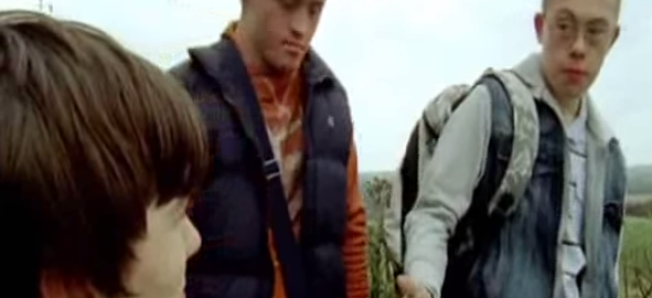 Three people are outside in hiking gear