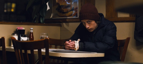 A person leans over a table at a restaurant