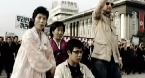 A group of people gather outside a building