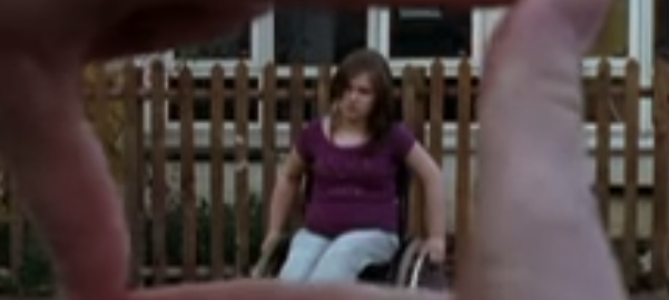 Two hands from a woman in a wheelchair