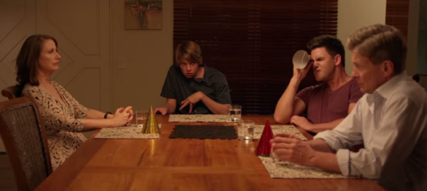 A family sits at a kitchen table
