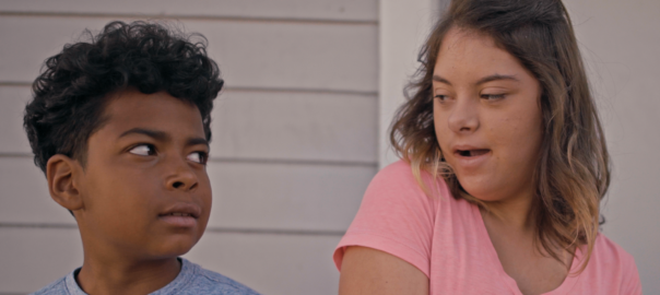 A boy and a girl look at each other