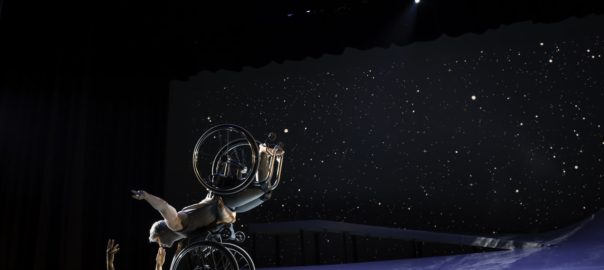 Two people in wheelchairs dance