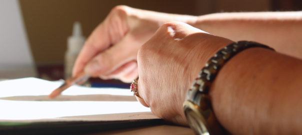 A hand draws on paper