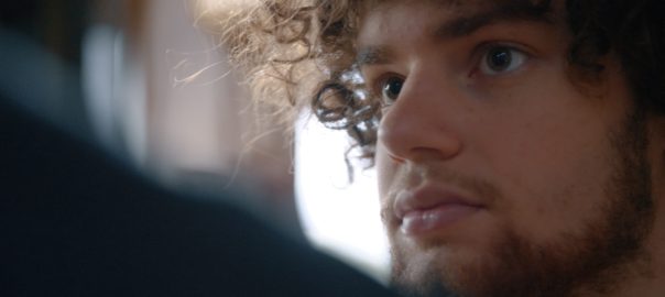 a young man looks to his left