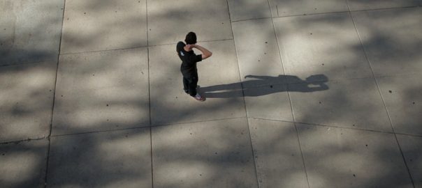 A man stands alone on concrete