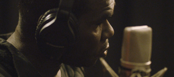A man is in front of a microphone