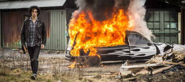A man walks away from a burning truck