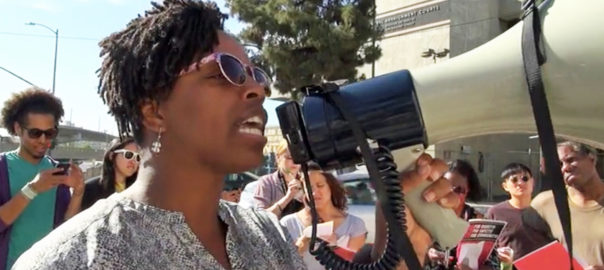 A woman speaks into a megaphone