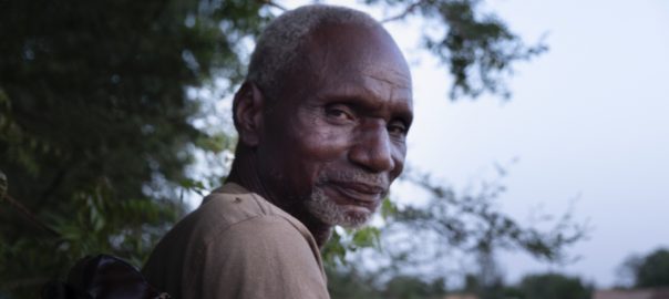 A portrait of a man with trees in the background